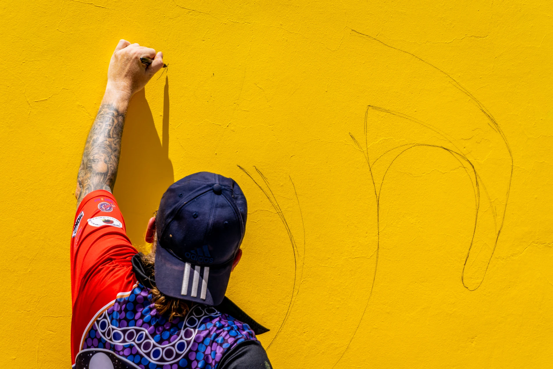 Orana Arts: Alley Gallery Photography 1 Person Sketching Tattoos Yellow Wall