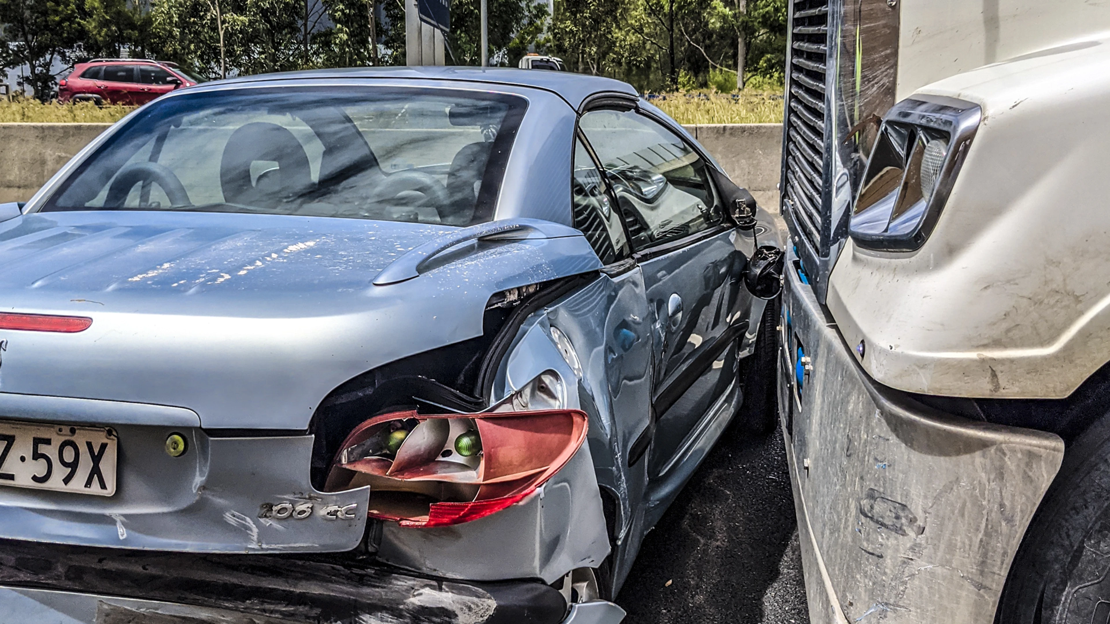 Part Two: That Time I Was Hit By A Truck 1 Damaged Silver Car Collides With White Truck; Red Suv And Trees In Background.