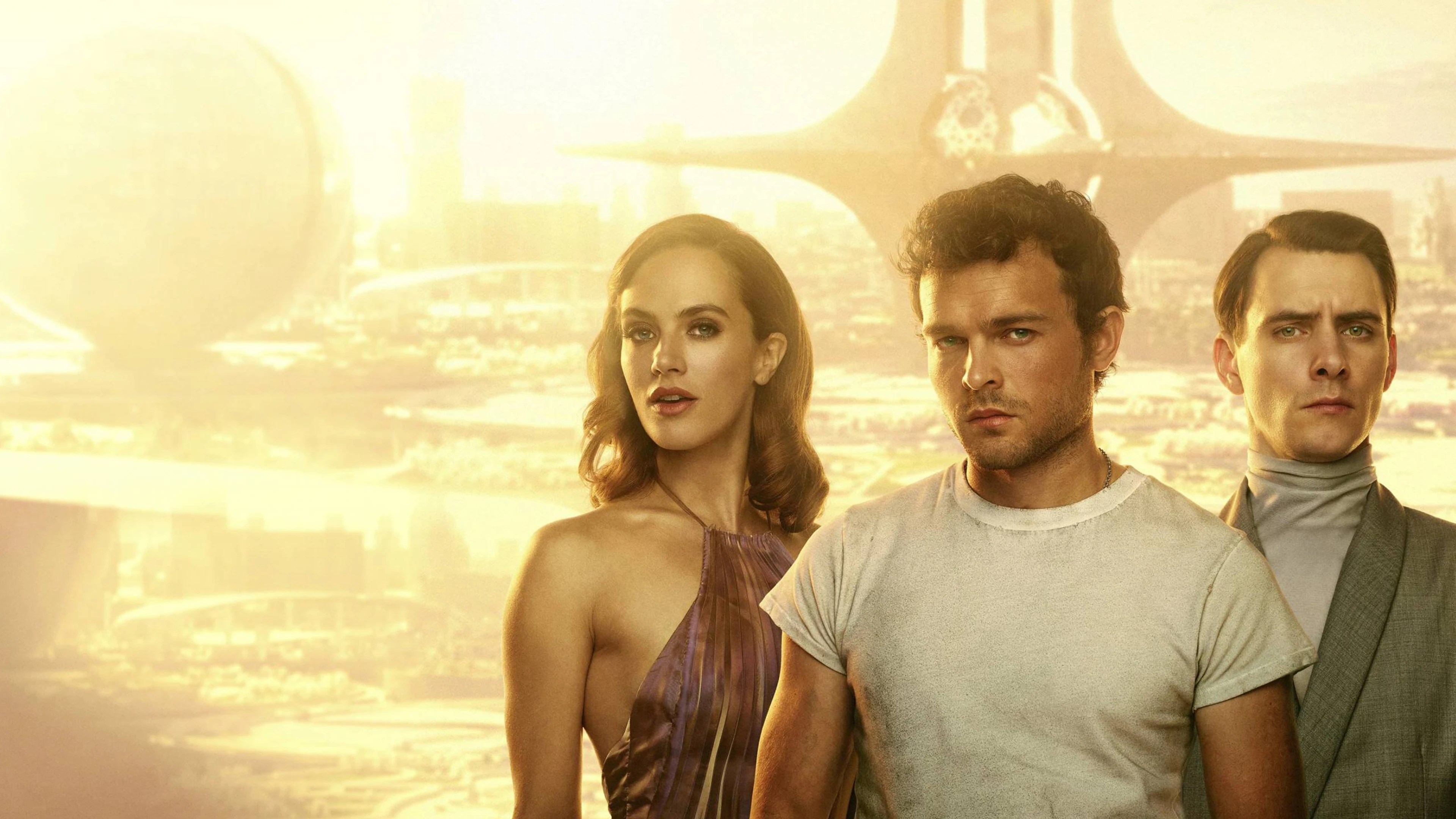 Three people in front of a golden futuristic cityscape with unique architecture suggesting sci-fi.